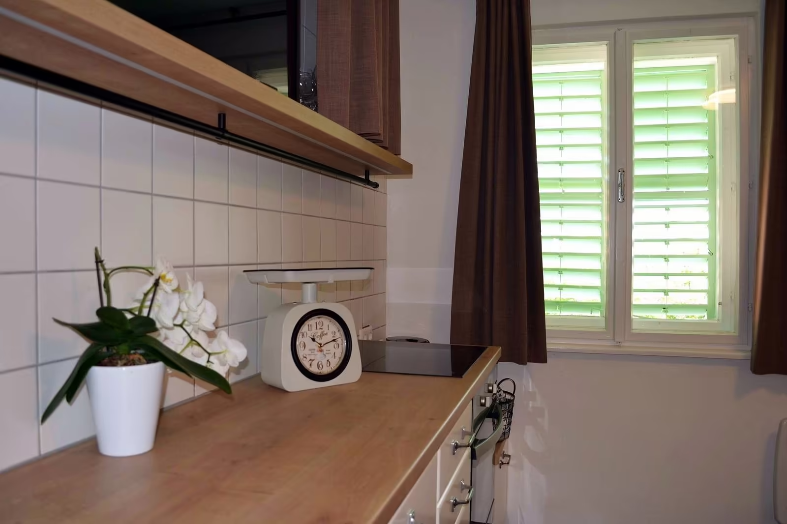 Renovated kitchen with green shutters